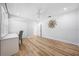Spacious bedroom featuring light-colored floors, a ceiling fan, a closet, and a built-in desk with drawers at 722 N Manasota Key Rd, Englewood, FL 34223
