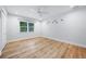 Bedroom featuring light-colored floors, a ceiling fan, and a window with natural light at 722 N Manasota Key Rd, Englewood, FL 34223