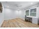 Bedroom featuring light-colored floors, a ceiling fan, and a window above a built-in desk with drawers at 722 N Manasota Key Rd, Englewood, FL 34223