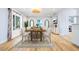 Bright and airy dining room with wooden table, light walls, and an area rug at 722 N Manasota Key Rd, Englewood, FL 34223