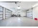 Spacious three-car garage with updated epoxy flooring and plenty of storage at 722 N Manasota Key Rd, Englewood, FL 34223