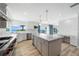 Kitchen view features a stone countertop island, modern stainless appliances, and ocean views at 722 N Manasota Key Rd, Englewood, FL 34223
