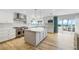 Gourmet kitchen with stainless steel appliances, center island, and access to outdoor beachside dining at 722 N Manasota Key Rd, Englewood, FL 34223