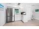 The kitchen features stainless steel appliances, bright white cabinets, and a window at 722 N Manasota Key Rd, Englewood, FL 34223