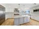 Bright kitchen with large center island, stainless steel appliances, and stylish pendant lighting at 722 N Manasota Key Rd, Englewood, FL 34223