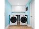 Laundry room with side-by-side washer and dryer and overhead cabinets at 722 N Manasota Key Rd, Englewood, FL 34223