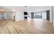 Spacious living room with a fireplace, hardwood floors, and scenic views from the large sliding doors at 722 N Manasota Key Rd, Englewood, FL 34223