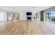 Open living room boasts a modern fireplace, wood floors, access to the kitchen, and beautiful views of the beach at 722 N Manasota Key Rd, Englewood, FL 34223