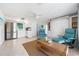 Open concept living room and kitchen with stainless steel appliances and spiral staircase at 722 N Manasota Key Rd, Englewood, FL 34223