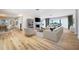 Open living room with fireplace, wood floors, and large windows with ocean views at 722 N Manasota Key Rd, Englewood, FL 34223