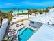 Aerial view of a private pool and deck with comfortable seating overlooking the beach at 722 N Manasota Key Rd, Englewood, FL 34223