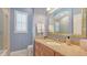 Bathroom features a granite countertop, wood cabinets, a large mirror, and a tiled shower with a glass door at 7305 Chatsworth Ct, University Park, FL 34201