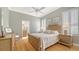 Light and airy bedroom with plantation shutters, bamboo floors, and an ensuite bathroom at 7305 Chatsworth Ct, University Park, FL 34201