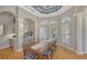 Elegant dining room showcasing coffered ceiling, archway, chandelier, and natural light creating an inviting atmosphere at 7305 Chatsworth Ct, University Park, FL 34201