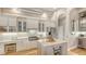 Well-equipped kitchen featuring white cabinets, stainless steel appliances, a gray island, and hardwood floors at 7305 Chatsworth Ct, University Park, FL 34201