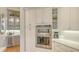 Modern kitchen with white cabinets, built-in stainless steel appliances, and a wine cooler at 7305 Chatsworth Ct, University Park, FL 34201