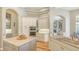 Spacious kitchen featuring white cabinets, stainless steel appliances, an island, and hardwood flooring at 7305 Chatsworth Ct, University Park, FL 34201