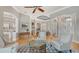 Spacious and well-lit living room featuring hardwood floors, white walls, and decorative archways at 7305 Chatsworth Ct, University Park, FL 34201