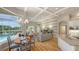 Open-concept living space with coffered ceilings, pool views, a dining area, kitchen and a casual living area at 7305 Chatsworth Ct, University Park, FL 34201