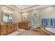 The main bathroom features granite countertops, dual sinks, a soaking tub, and a window with plantation shutters at 7305 Chatsworth Ct, University Park, FL 34201