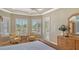 Bright main bedroom with a sitting area overlooking the pool through shuttered windows at 7305 Chatsworth Ct, University Park, FL 34201