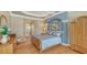Comfortable main bedroom features bamboo flooring, elegant decor, tray ceilings and an ensuite bathroom at 7305 Chatsworth Ct, University Park, FL 34201