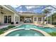 Inviting pool with spa and lounging area within a screened lanai, perfect for relaxation and entertainment at 7305 Chatsworth Ct, University Park, FL 34201