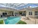 Relaxing pool with sun loungers, integrated spa, and screened enclosure, perfect for outdoor enjoyment at 7305 Chatsworth Ct, University Park, FL 34201