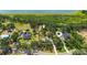 Aerial view of a property showcasing its spacious lot, mature trees, and proximity to a nearby lake at 7407 91St E St, Palmetto, FL 34221