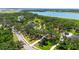 Scenic aerial view of a home nestled among mature trees, near a lake, in a suburban setting at 7407 91St E St, Palmetto, FL 34221