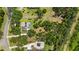 Overhead view of the property highlighting a swimming pool, surrounding greenery, and neighborhood at 7407 91St E St, Palmetto, FL 34221