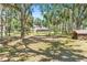 Spacious backyard featuring mature trees, a shed, and partial views of the home at 7407 91St E St, Palmetto, FL 34221