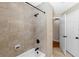 Bright bathroom features tiled walls, a tub with a shower, and neutral colors at 7407 91St E St, Palmetto, FL 34221