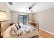 Cozy bedroom with a ceiling fan, wood floors, and sliding doors to the patio at 7407 91St E St, Palmetto, FL 34221