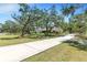 Picturesque home with a sprawling driveway and mature trees offering shade and privacy at 7407 91St E St, Palmetto, FL 34221