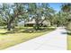 Beautiful home with a long driveway, lush lawn, and mature trees offering a serene and private setting at 7407 91St E St, Palmetto, FL 34221