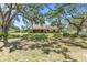 Quaint single-story home with a welcoming front porch and mature shade trees at 7407 91St E St, Palmetto, FL 34221