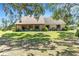Charming single-story home with a covered porch, lush landscaping, and a well-manicured lawn at 7407 91St E St, Palmetto, FL 34221