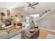 Cozy living room features a stone fireplace, vaulted ceilings, and elegant decor, creating a warm atmosphere at 7407 91St E St, Palmetto, FL 34221
