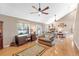 Open-concept living room boasts hardwood floors, a fireplace, and bright windows at 7407 91St E St, Palmetto, FL 34221