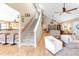 Open living space with staircase, wood floors, and modern decor with ceiling fans at 7407 91St E St, Palmetto, FL 34221