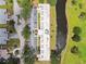 Aerial view of building complex with parking, landscaping, and scenic waterway at 7461 W Country Club Dr N # 408, Sarasota, FL 34243
