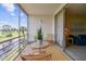 Balcony featuring seating overlooking the canal and golf course, with sliding door access to the living area at 7461 W Country Club Dr N # 408, Sarasota, FL 34243