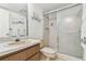 Bathroom features a single sink vanity, shower with glass sliding doors, and a toilet at 7461 W Country Club Dr N # 408, Sarasota, FL 34243