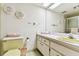 Bathroom features an retro yellow toilet, wall art, and a vanity with cabinets and drawers at 7461 W Country Club Dr N # 408, Sarasota, FL 34243