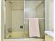 The bathroom features a combination tub and shower with sliding glass doors and tiled walls at 7461 W Country Club Dr N # 408, Sarasota, FL 34243