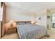 Relaxing bedroom with side tables, lamps, and a patterned comforter at 7461 W Country Club Dr N # 408, Sarasota, FL 34243