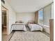 Bright bedroom with two beds, a large window, and an ensuite bathroom with glass door shower at 7461 W Country Club Dr N # 408, Sarasota, FL 34243