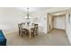 Carpeted dining area with views from the living room and bright natural light at 7461 W Country Club Dr N # 408, Sarasota, FL 34243
