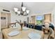 Bright dining area with golf course views and chandelier lighting at 7461 W Country Club Dr N # 408, Sarasota, FL 34243